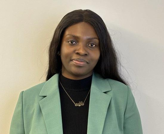 Maame Yaa Boakye, Class of 2020, in black shirt and green jacket.