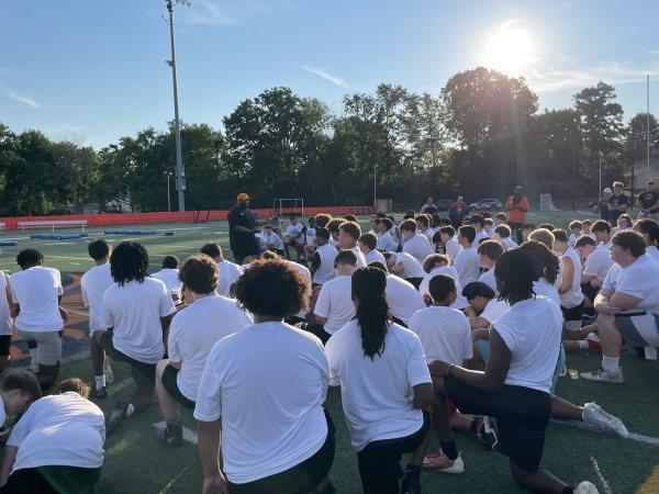 Players kneel on the field for A Call to Men Football Camp