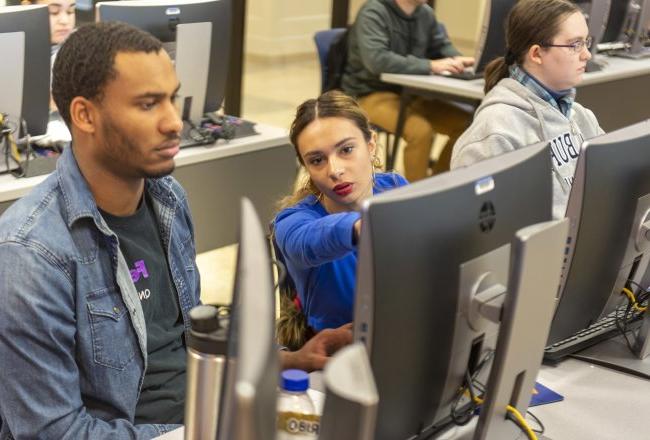 Business Student pointing to computer